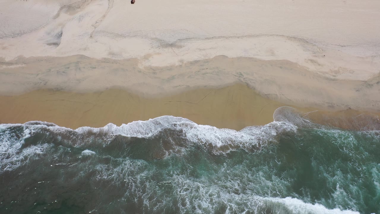 Overhead beach with surf and faint sand channels