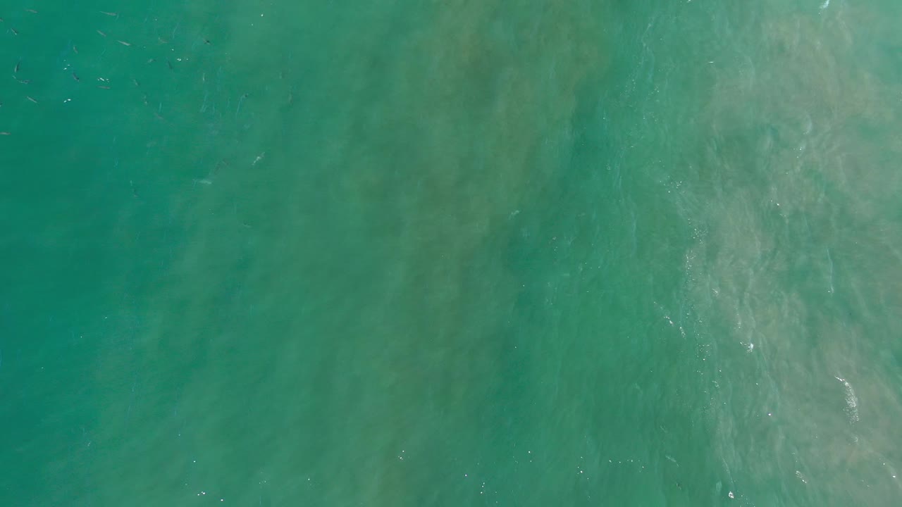 Turquoise water with lighter cloudy patches below the surface.