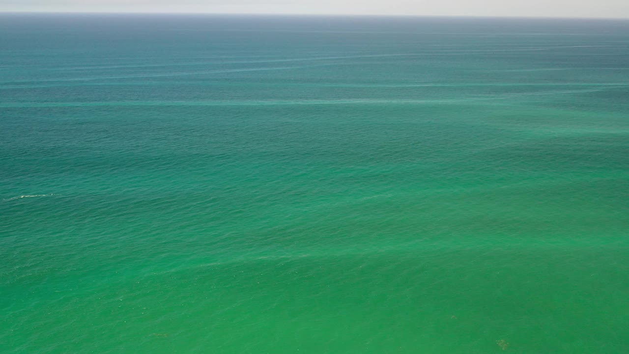 Open green water with small white streaks on the surface.
