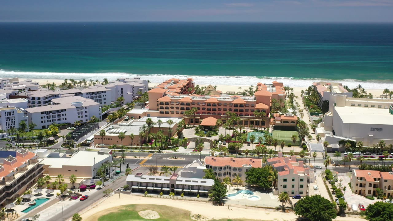 Aerial view of Los Cabos beachfront buildings and turquoise ocean