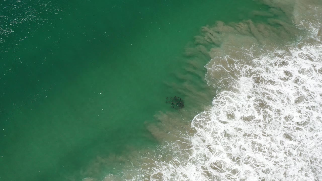 Overhead green seawater with white surf entering from the right