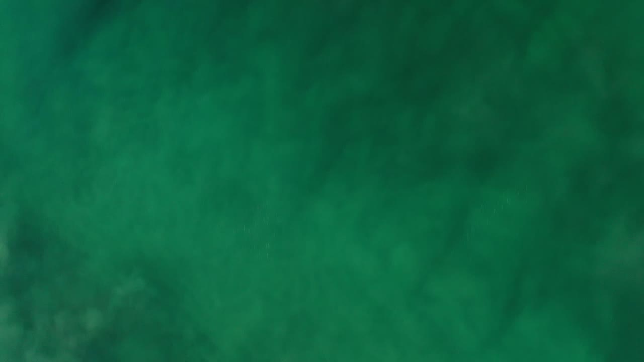 Soft green cloudy texture filling the frame.