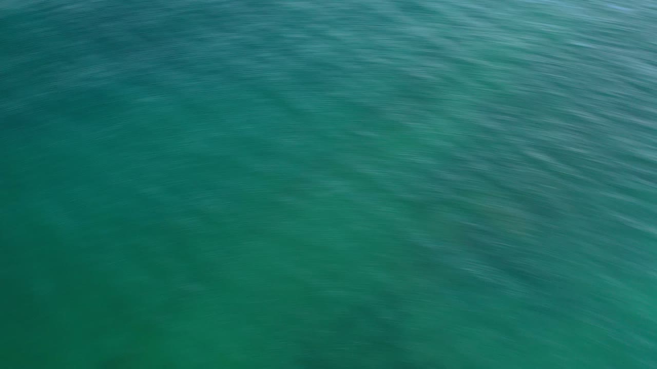 Overhead turquoise ocean water with faint ripples