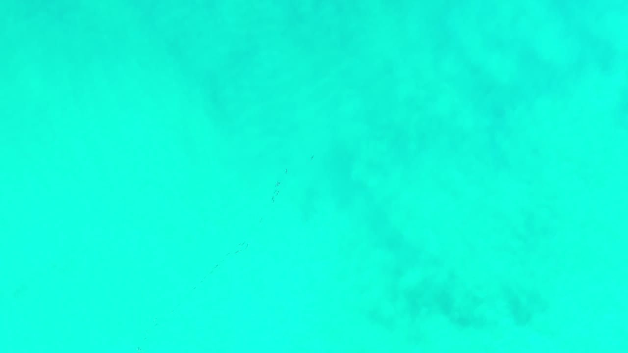 Overhead view of bright turquoise ocean water