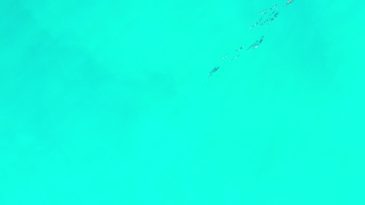 Turquoise ocean surface with faint pale wave streaks