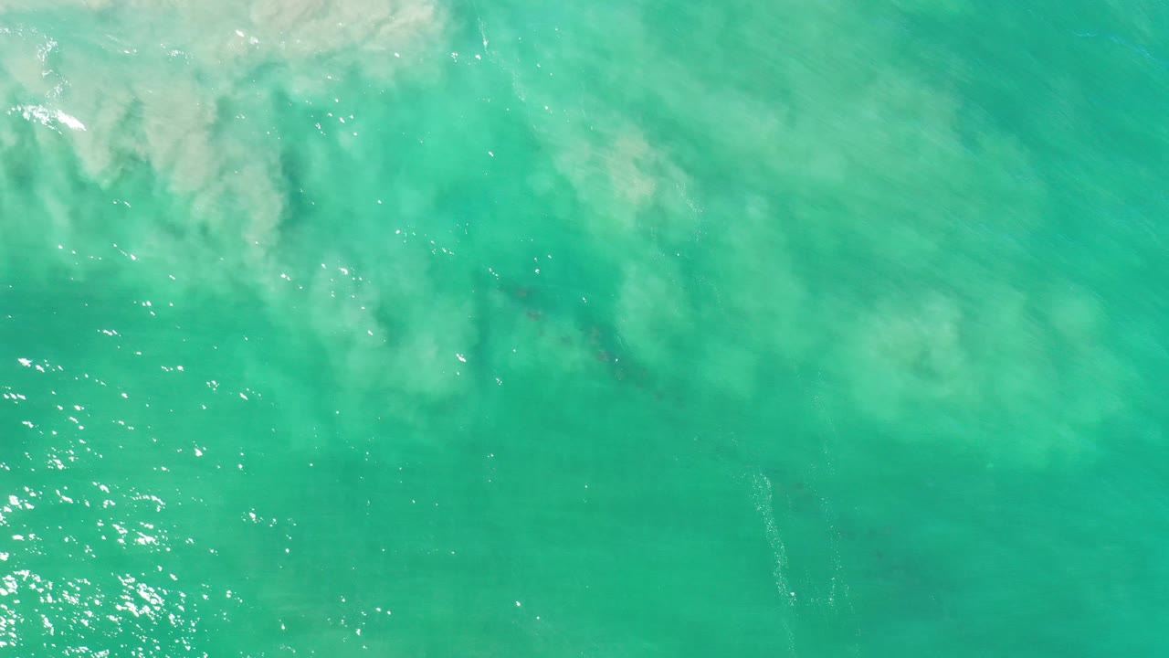 Turquoise water with pale cloudy surf texture