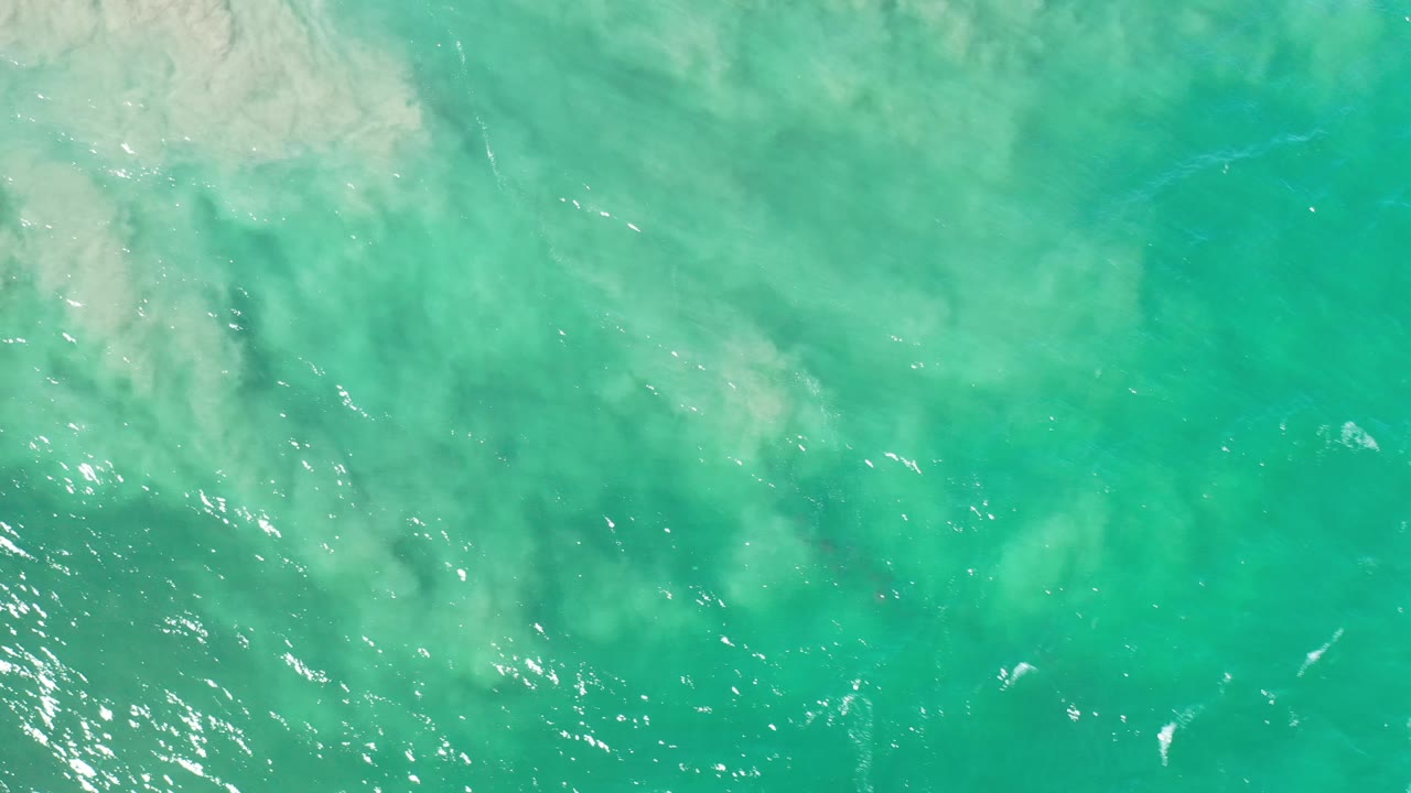 Turquoise water with brighter surface sparkle near the lower left.