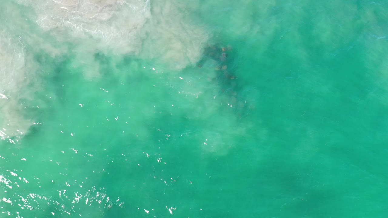 Aqua water with surf foam and sparkling highlights