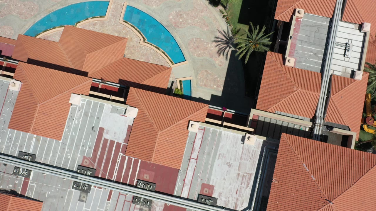 Overhead hotel roof pattern with blue curved water feature near the top edge.