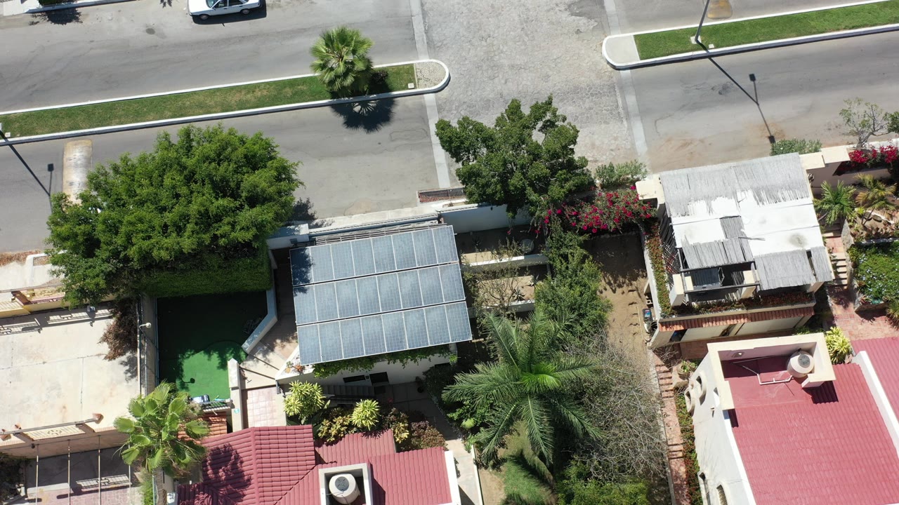 Overhead view of houses, trees, and a street.