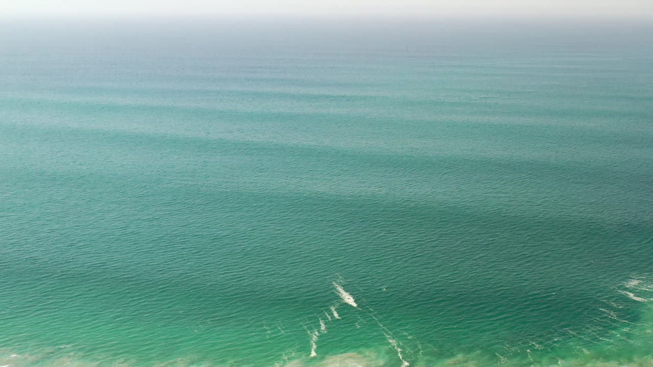 Green ocean surface under soft daylight