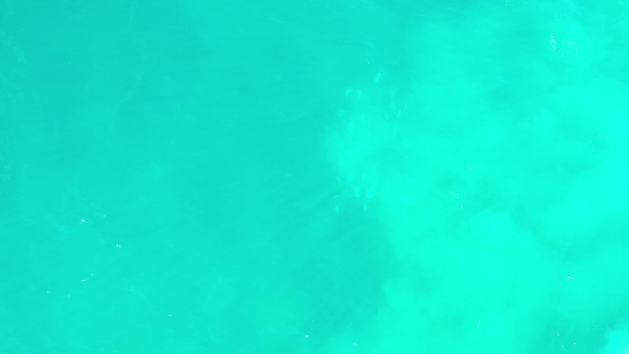Turquoise-green ocean water filling the frame.