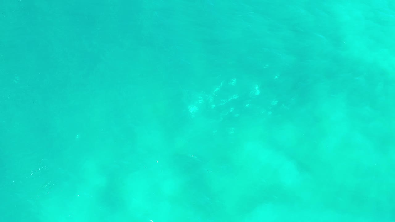 Aqua ocean with cloudy lighter patches