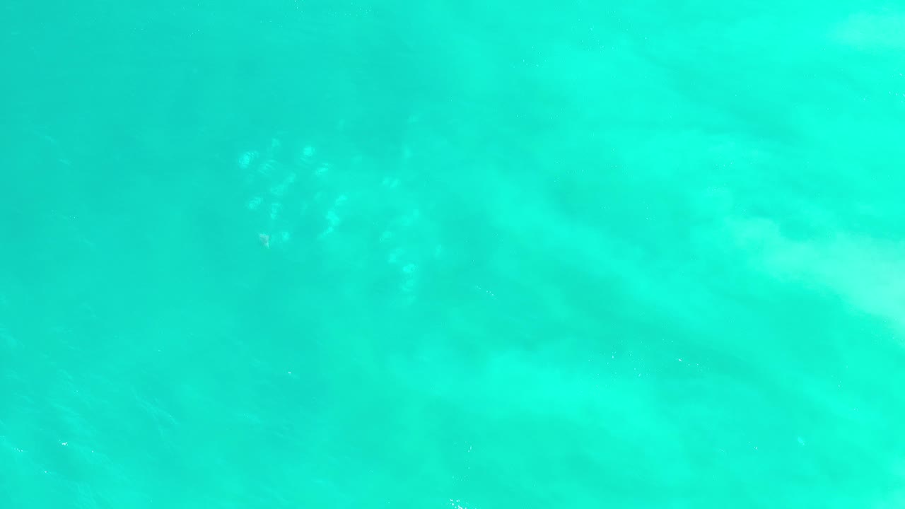 Sunlit turquoise water with faint white ripples