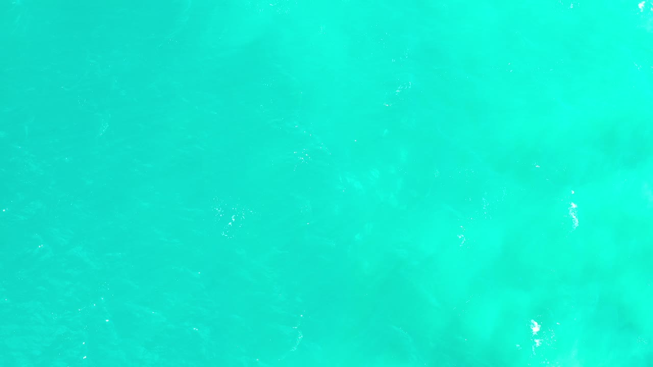 Overhead turquoise water in Los Cabos, Mexico shows soft ripples and pale underwater color variation with no visible people.