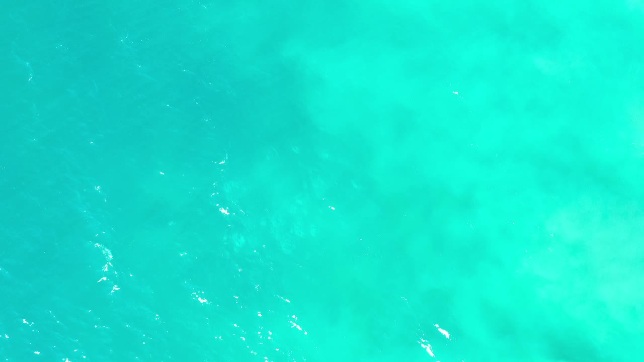 Turquoise water with scattered white highlights