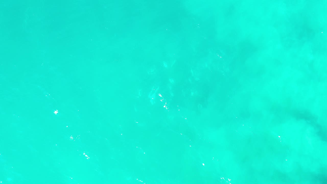 Bright aqua water with cloudy underwater shapes