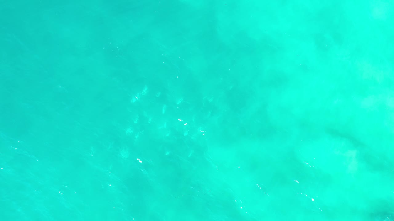 Aquamarine water texture with soft mottled shapes under the surface.