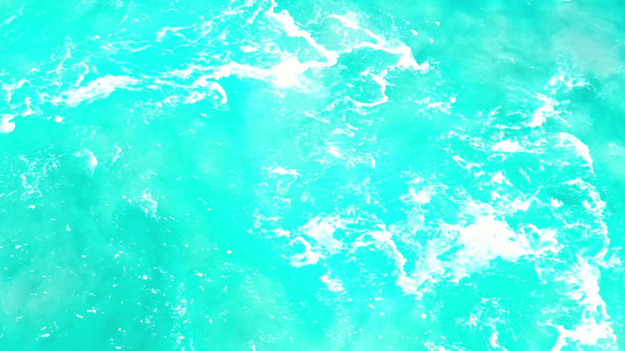 Aqua ocean surface with foamy white lines