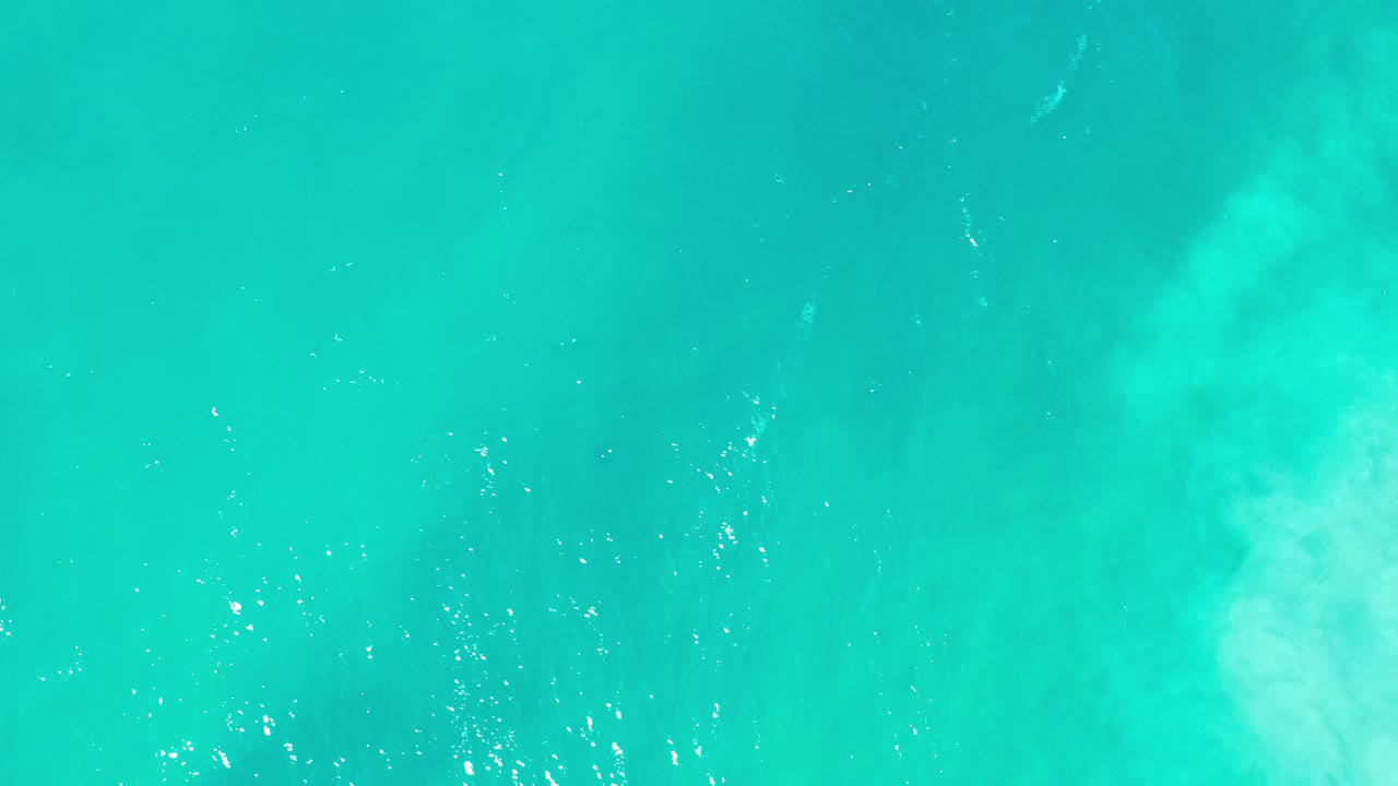 Turquoise ocean water with faint white wave texture