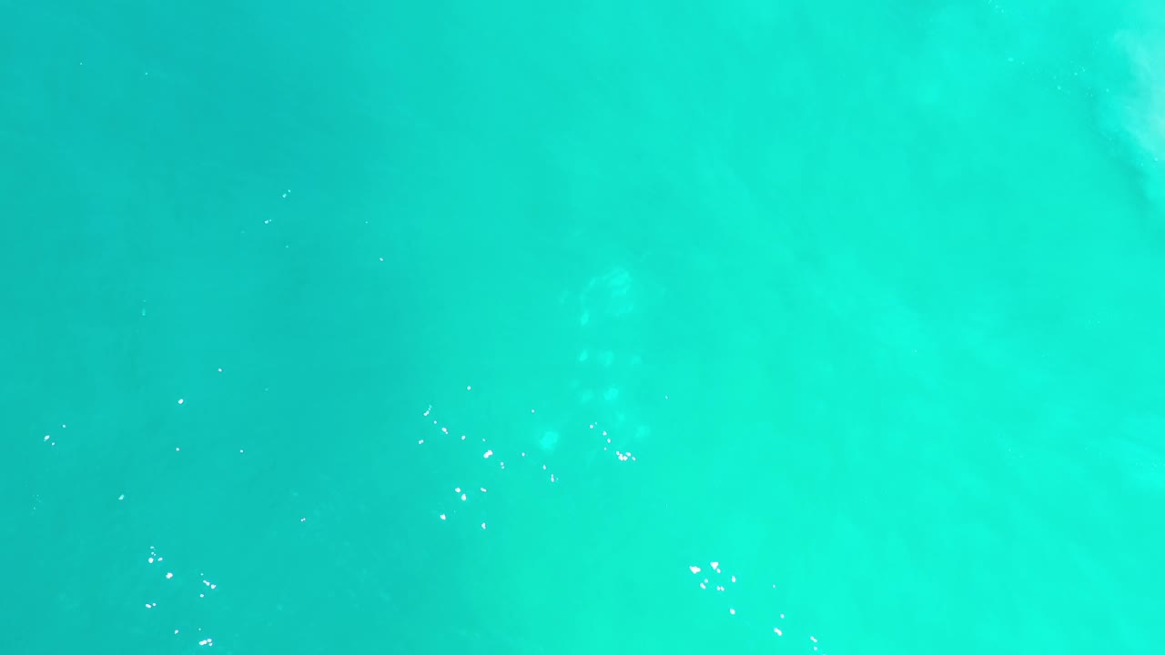 Turquoise water with a faint vertical wave pattern.