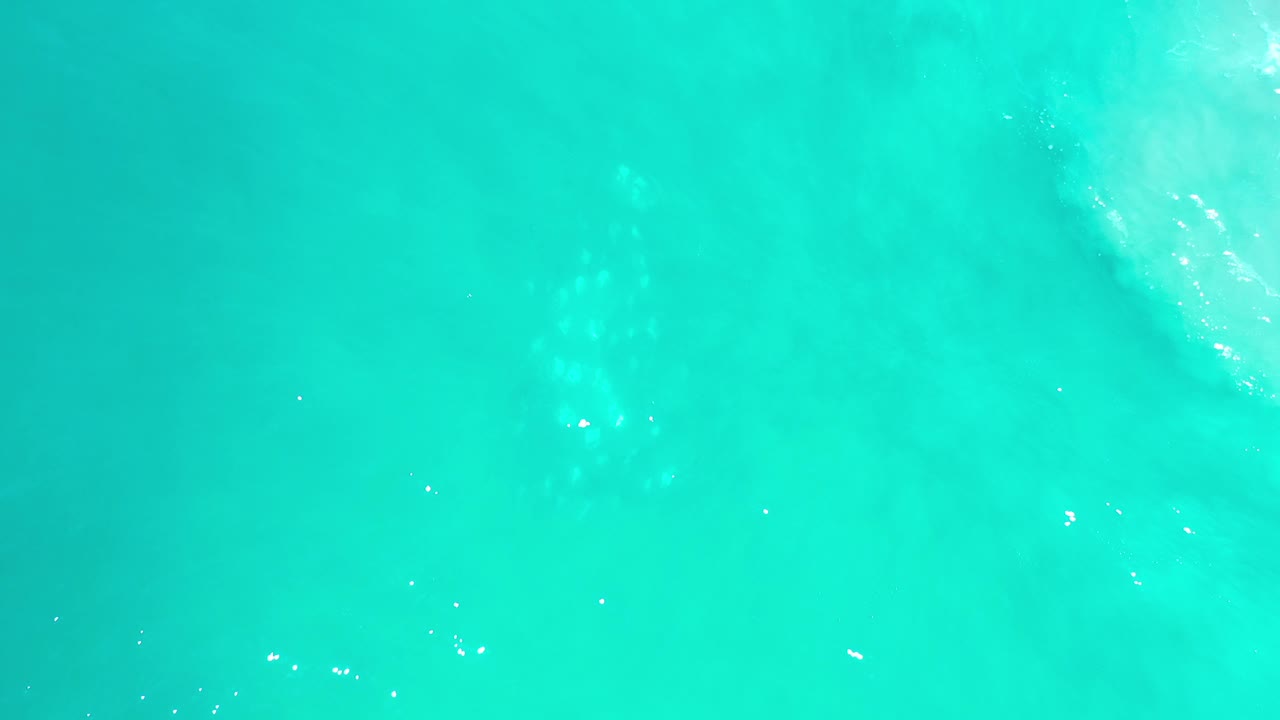 Green ocean surface with pale diagonal wash