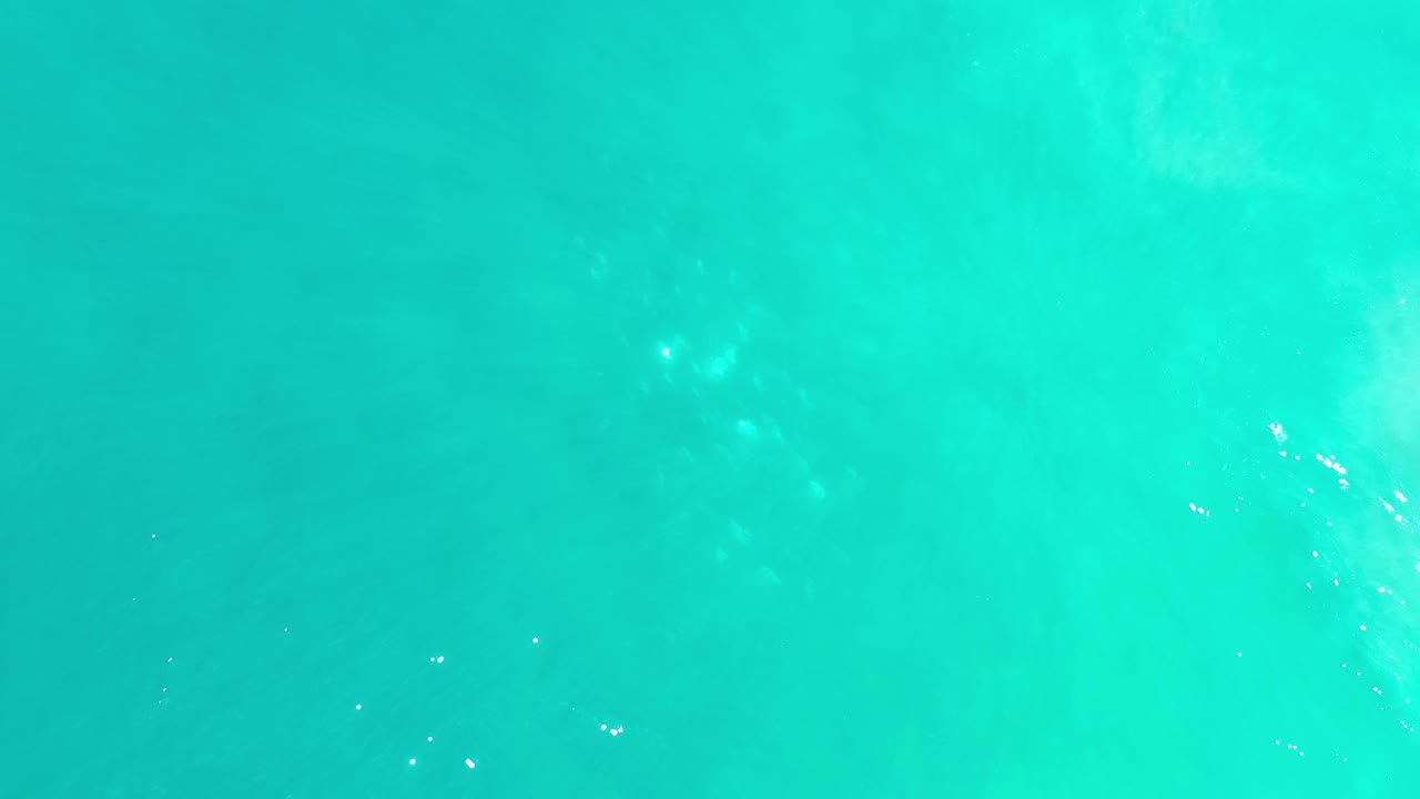 Bright aquamarine water with pale patches