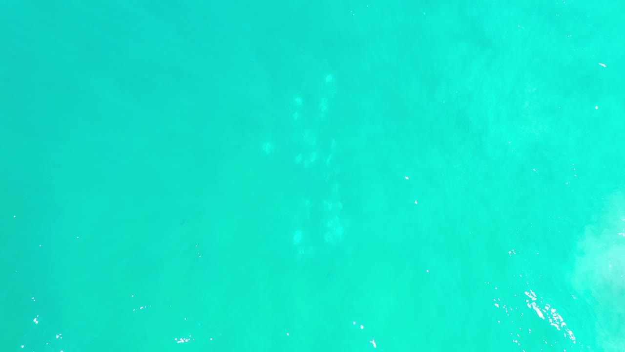 Soft aqua water texture with faint surface shimmer.