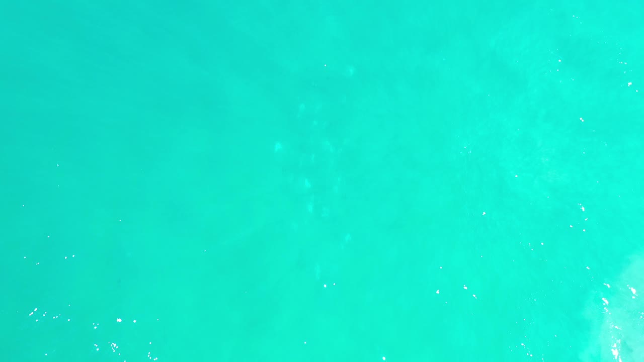 Bright turquoise water with pale underwater patches