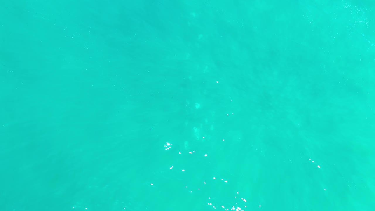 Bright aqua water with scattered sparkles