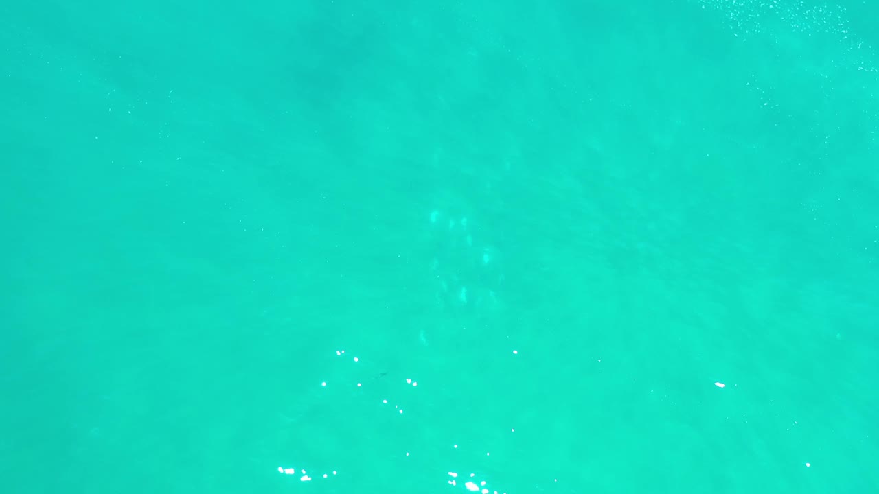 Clear aqua water in Los Cabos shows slightly shifted ripple patterns and small white highlights across an otherwise empty frame with no visible people.