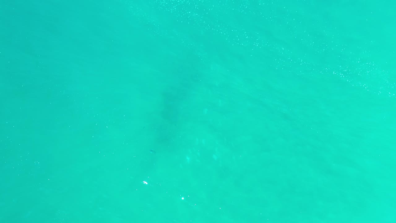 Turquoise sea water with faint underwater shadows
