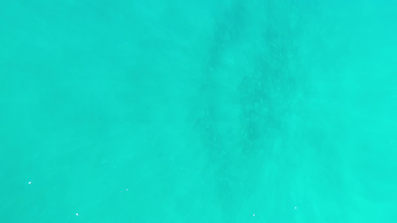 Aerial-style view of clear turquoise water with subtle surface texture.