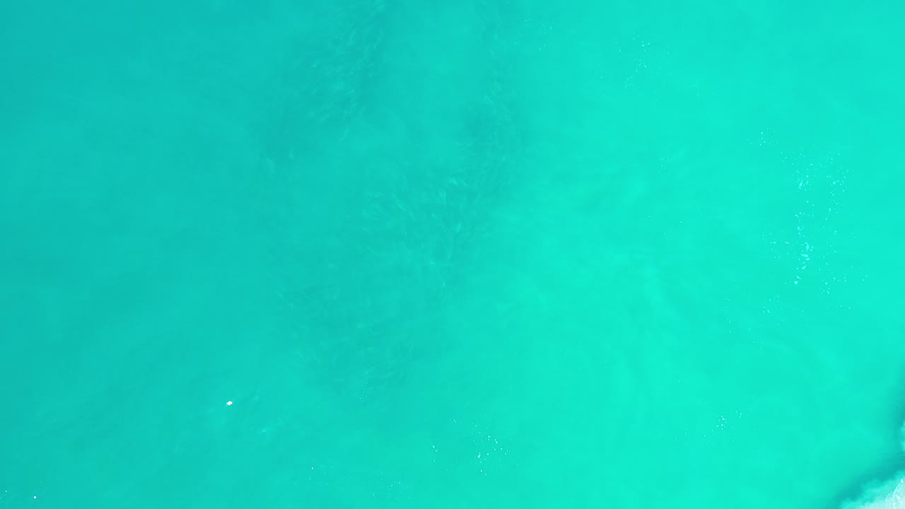 Overhead turquoise water with faint darker patches