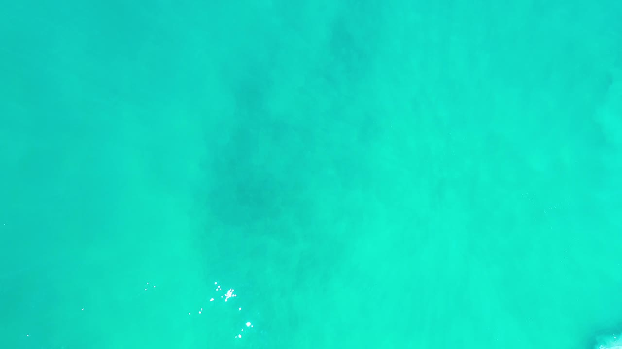 Aerial water texture with a small bright ripple