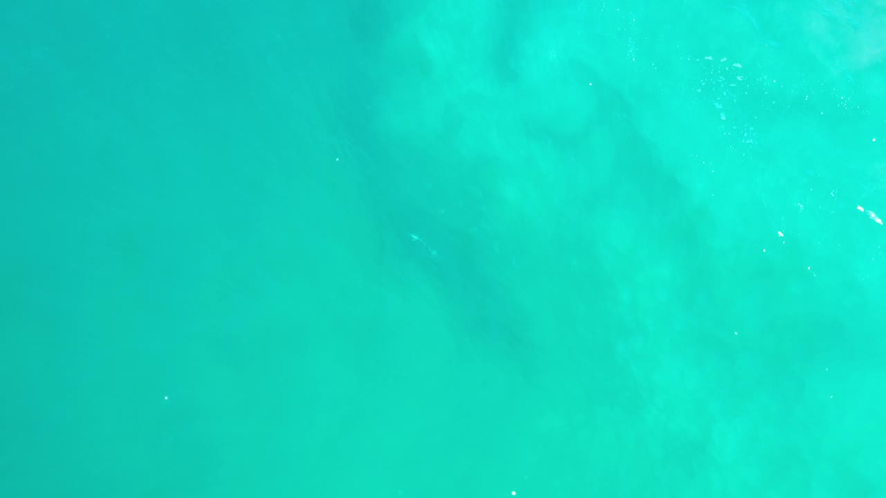 Overhead sea surface with turquoise color and light flecks.