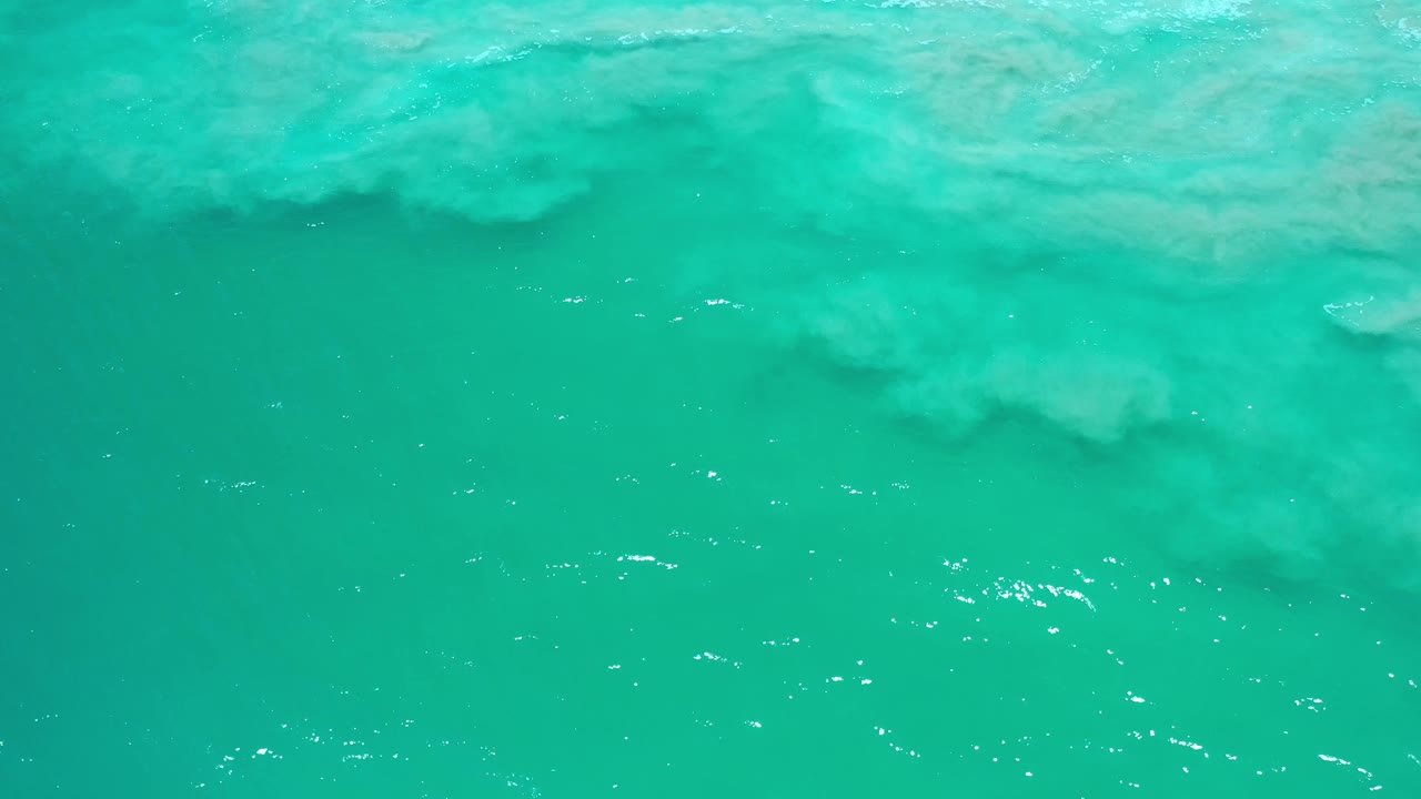 Transparent turquoise water with white glints