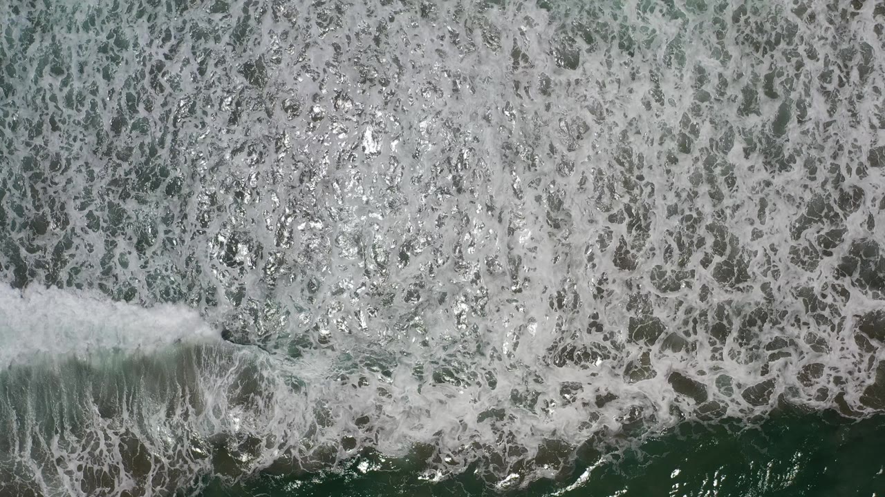 Foam pattern with a wave crest near the lower edge