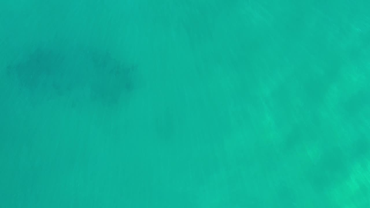 Calm green water with soft tonal bands.