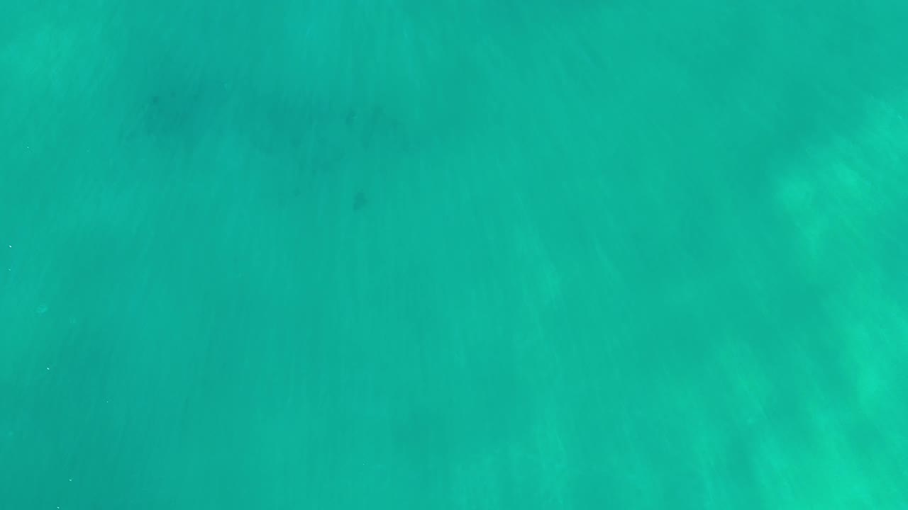 Overhead Los Cabos water frame with green-blue color, pale wave streaking, and no visible people or objects.