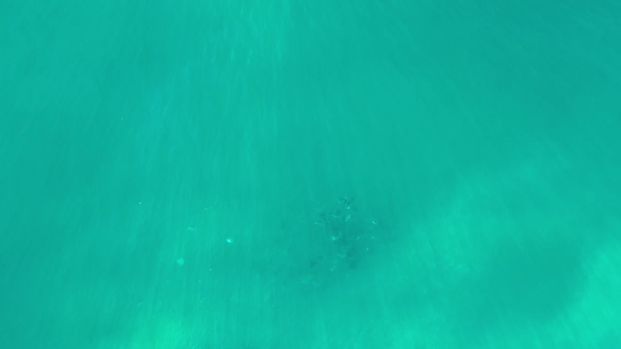 Aerial turquoise water with faint shadow patterns