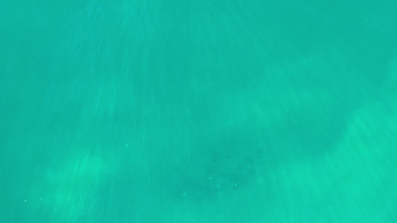 Blue green water with cloudy underwater shapes