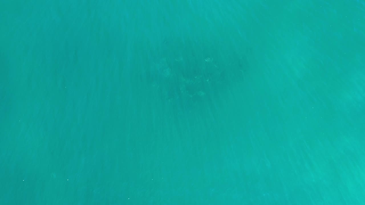 Green-blue water from Los Cabos, Mexico shows subtle darker patches near the upper area and no visible people.