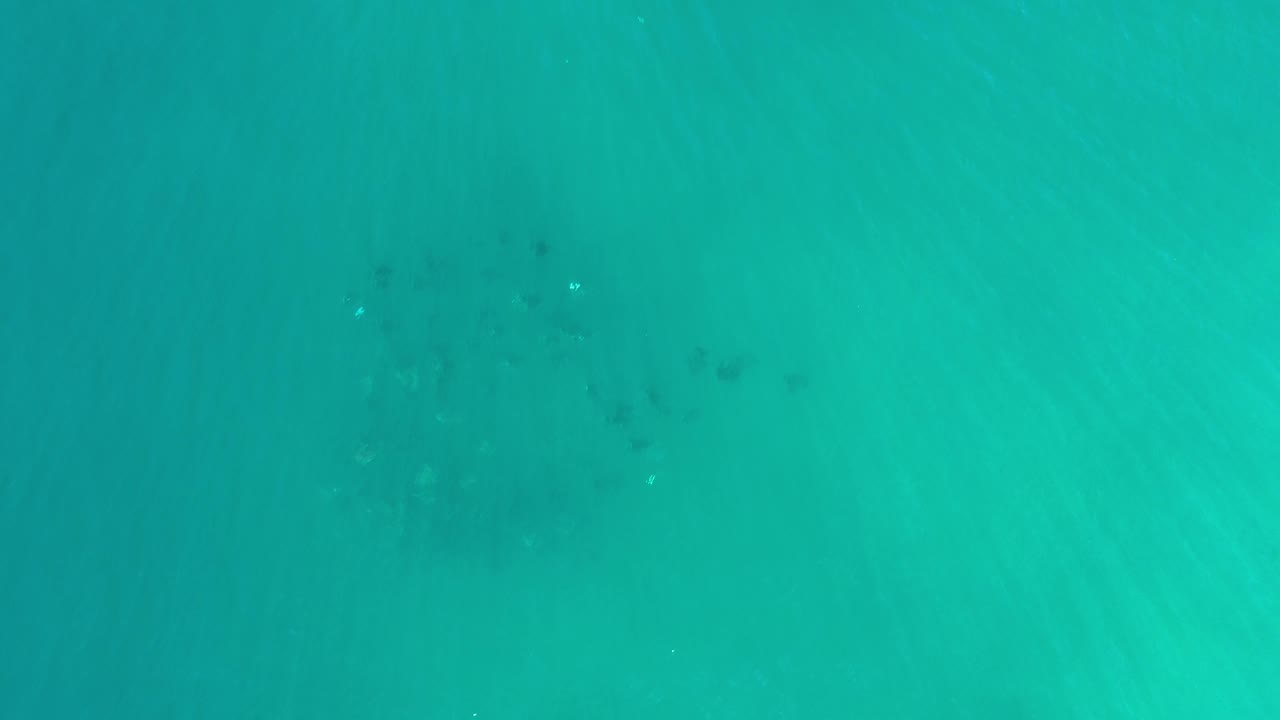 Underwater blue water with darker patches near center