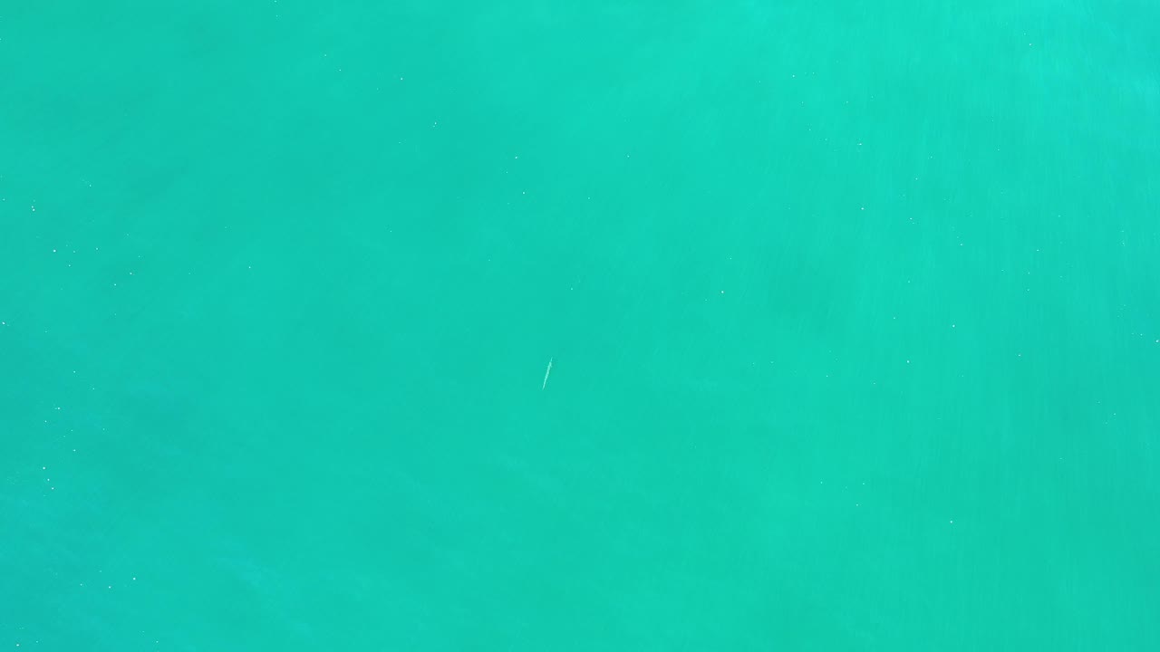 Clear turquoise water fills the opening frame in Los Cabos, Mexico, with soft tonal variation and no visible people.