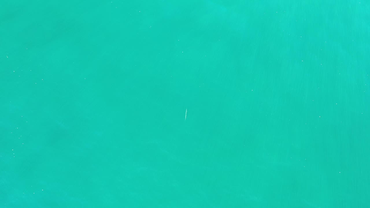 Open turquoise water with faint vertical texture