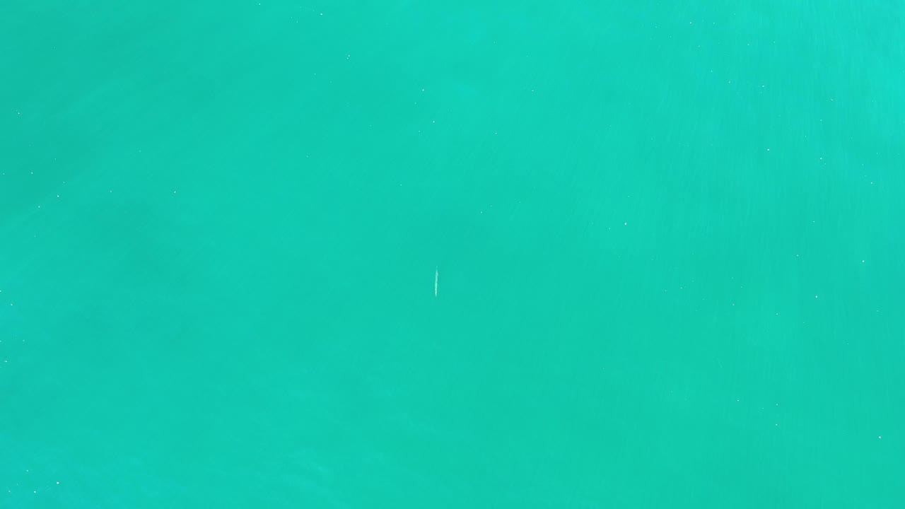 Abstract turquoise water with tiny bright flecks