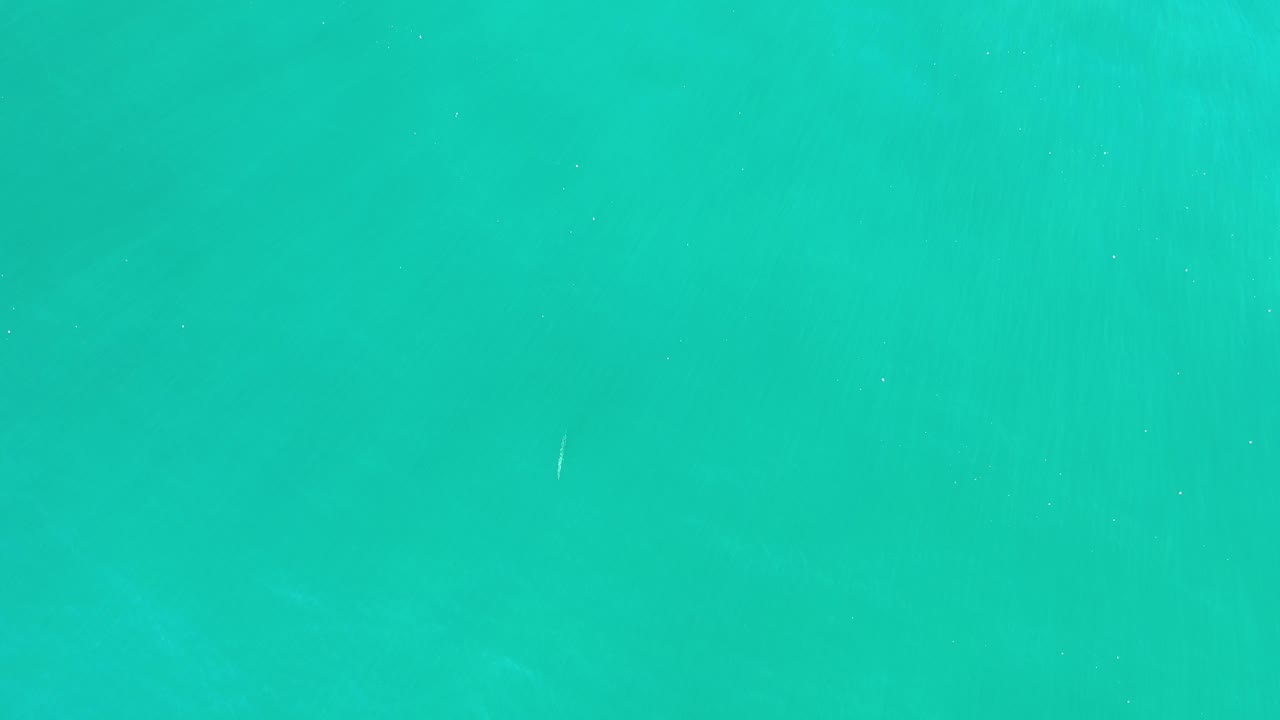 Aquamarine ocean surface with faint ripples.