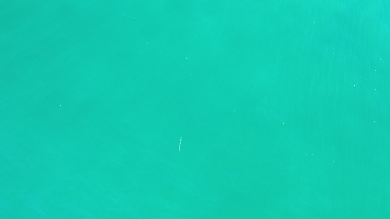 Turquoise-green ocean water with faint ripples