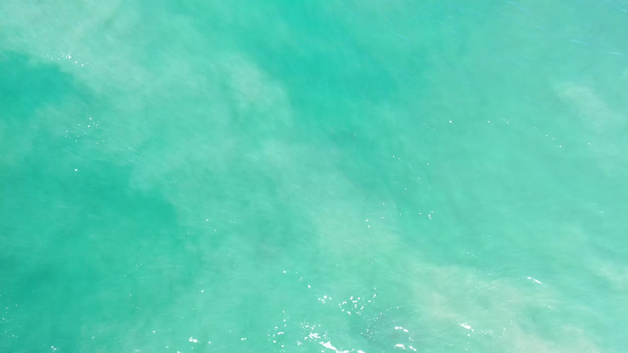 Open turquoise water with scattered sparkle highlights